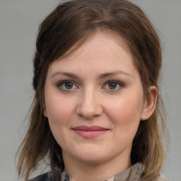 Joyful white young-adult female with medium  brown hair and grey eyes