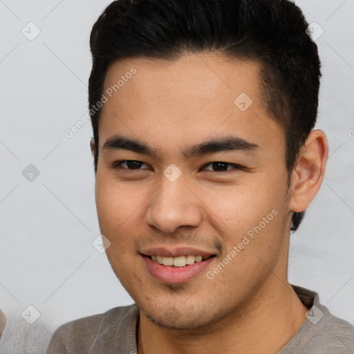 Joyful latino young-adult male with short  brown hair and brown eyes