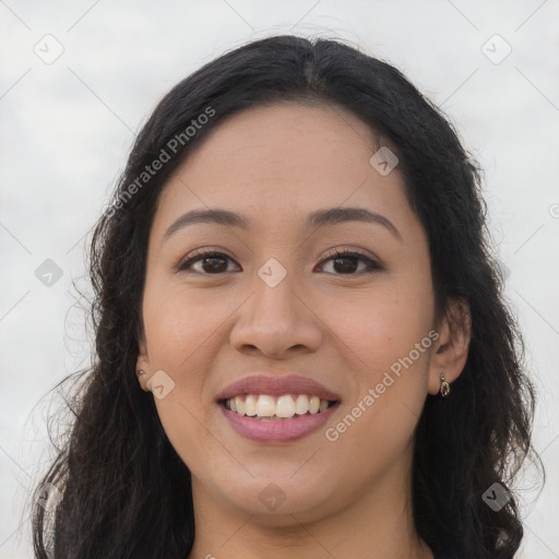 Joyful latino young-adult female with long  brown hair and brown eyes