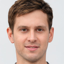 Joyful white young-adult male with short  brown hair and grey eyes