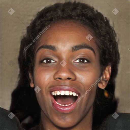 Joyful black young-adult female with long  black hair and brown eyes