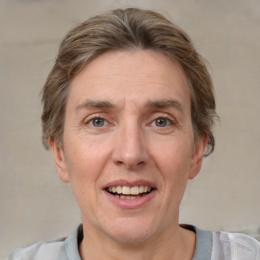 Joyful white adult male with short  brown hair and grey eyes