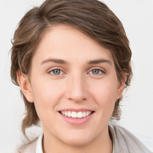 Joyful white young-adult female with medium  brown hair and blue eyes