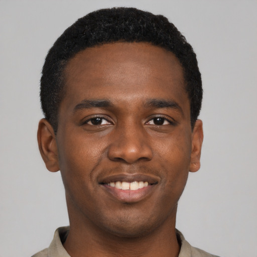 Joyful black young-adult male with short  black hair and brown eyes