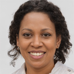 Joyful black adult female with medium  brown hair and brown eyes