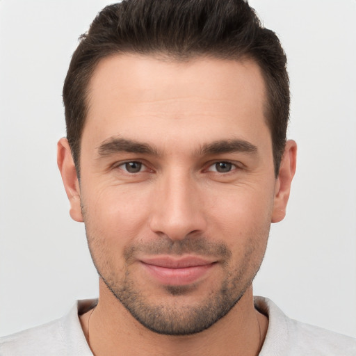 Joyful white young-adult male with short  brown hair and brown eyes