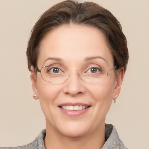 Joyful white adult female with short  brown hair and grey eyes