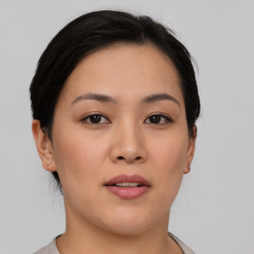 Joyful asian young-adult female with short  brown hair and brown eyes