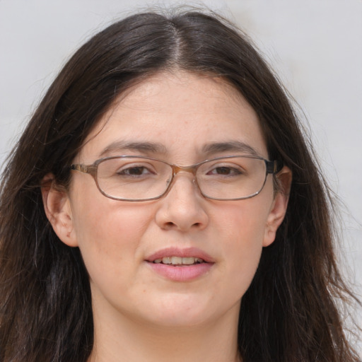 Joyful white adult female with long  brown hair and brown eyes