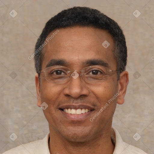 Joyful black adult male with short  black hair and brown eyes