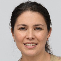 Joyful white young-adult female with medium  brown hair and brown eyes