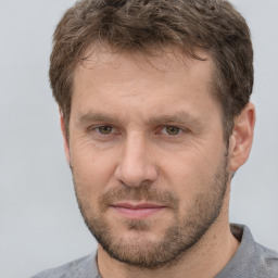 Joyful white adult male with short  brown hair and grey eyes