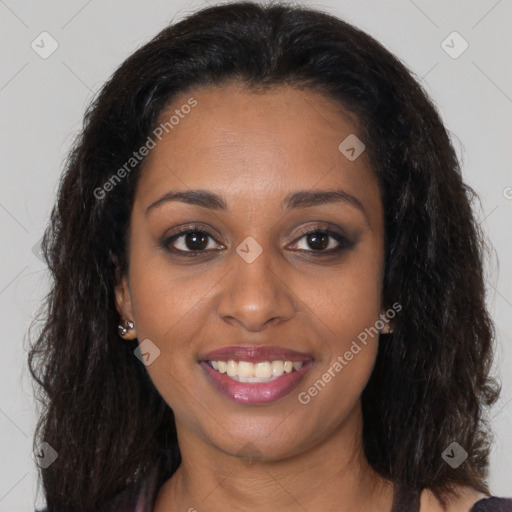 Joyful black young-adult female with long  brown hair and brown eyes