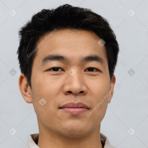 Joyful asian young-adult male with short  brown hair and brown eyes