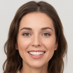 Joyful white young-adult female with long  brown hair and green eyes