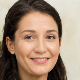 Joyful white adult female with long  brown hair and brown eyes