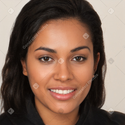 Joyful latino young-adult female with long  brown hair and brown eyes