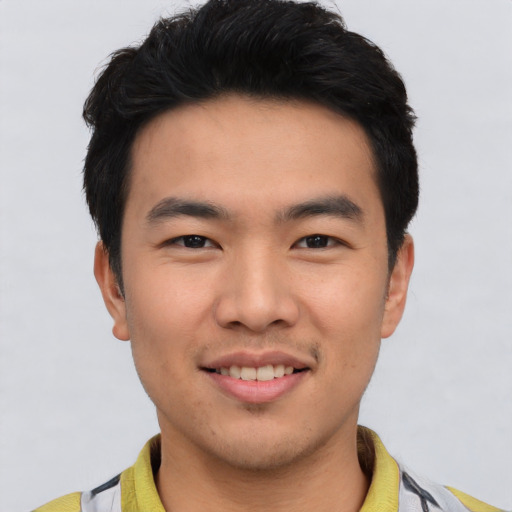 Joyful asian young-adult male with short  black hair and brown eyes