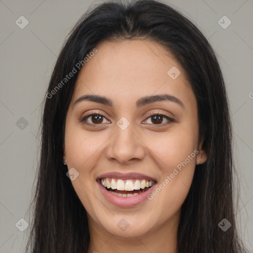 Joyful latino young-adult female with long  brown hair and brown eyes