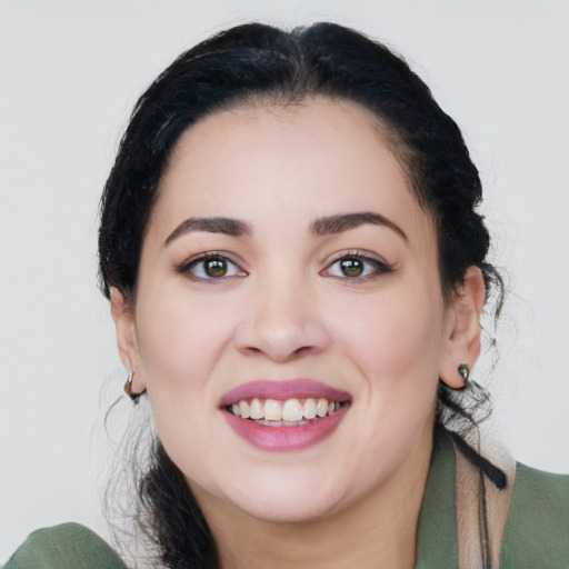 Joyful white young-adult female with medium  black hair and green eyes