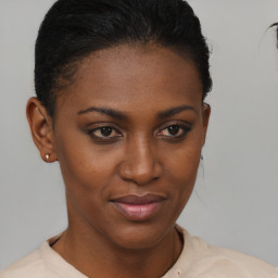 Joyful black young-adult female with short  brown hair and brown eyes