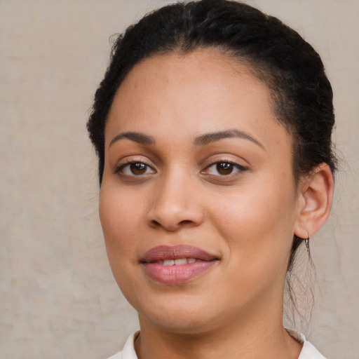 Joyful black young-adult female with medium  brown hair and brown eyes