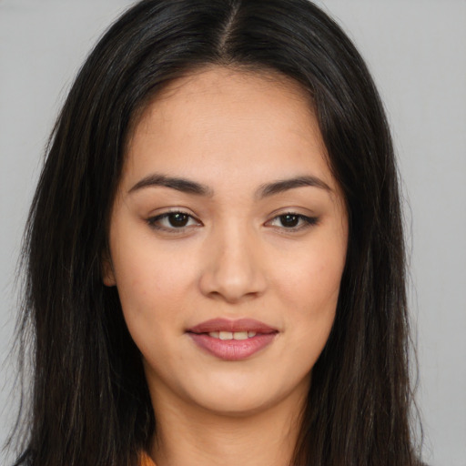 Joyful asian young-adult female with long  brown hair and brown eyes