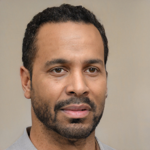 Neutral latino adult male with short  black hair and brown eyes