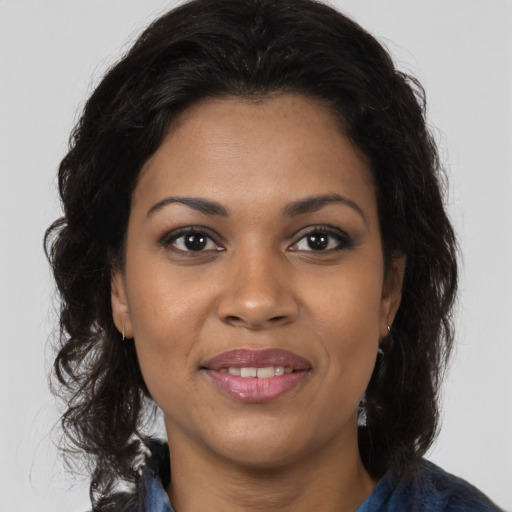 Joyful black young-adult female with medium  brown hair and brown eyes