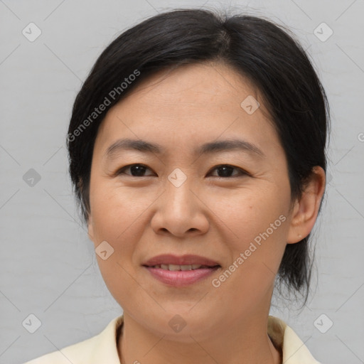 Joyful asian adult female with medium  brown hair and brown eyes