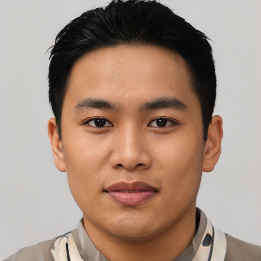 Joyful asian young-adult male with short  black hair and brown eyes