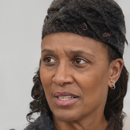 Joyful black adult female with short  brown hair and brown eyes