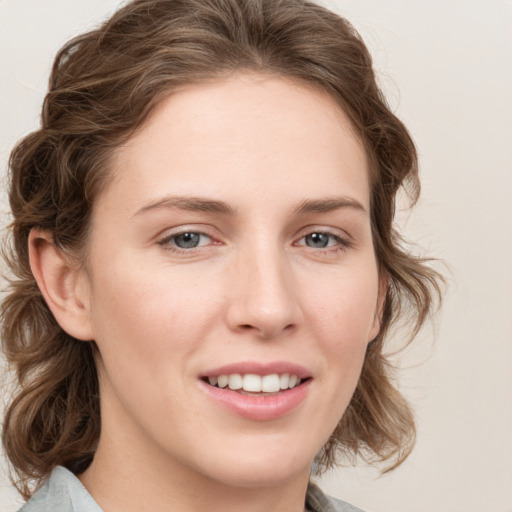 Joyful white young-adult female with medium  brown hair and blue eyes