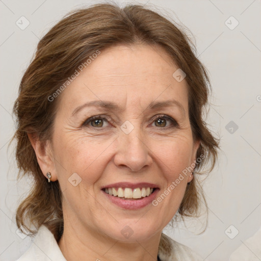 Joyful white adult female with medium  brown hair and green eyes