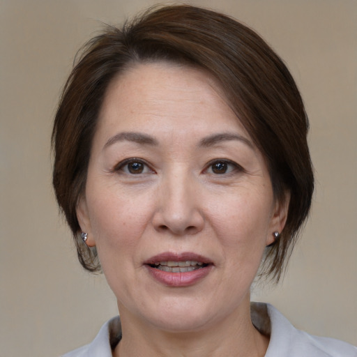 Joyful white adult female with medium  brown hair and brown eyes