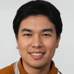 Joyful asian young-adult male with short  black hair and brown eyes