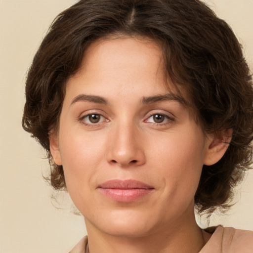 Joyful white young-adult female with medium  brown hair and green eyes