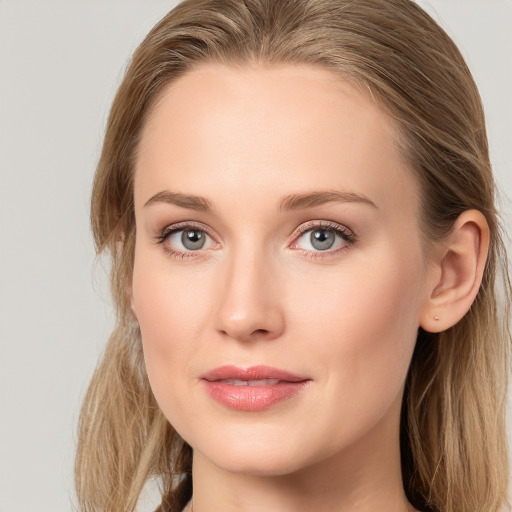 Joyful white young-adult female with long  brown hair and blue eyes