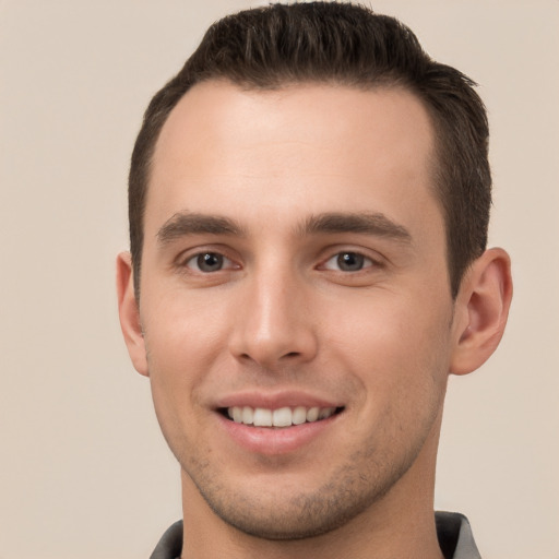 Joyful white young-adult male with short  brown hair and brown eyes