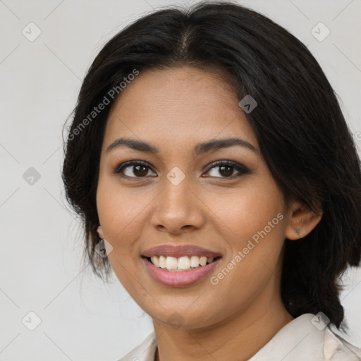 Joyful latino young-adult female with medium  brown hair and brown eyes