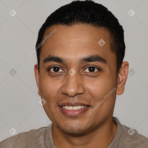 Joyful black young-adult male with short  black hair and brown eyes