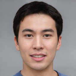 Joyful asian young-adult male with short  brown hair and brown eyes