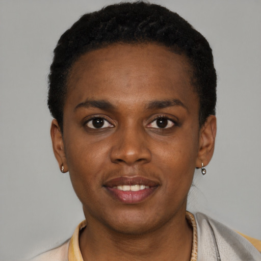 Joyful black young-adult female with short  black hair and brown eyes