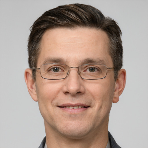 Joyful white adult male with short  brown hair and grey eyes