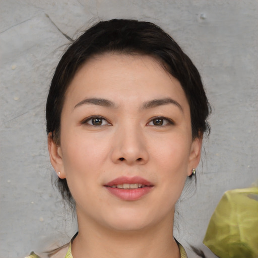Joyful asian young-adult female with short  brown hair and brown eyes