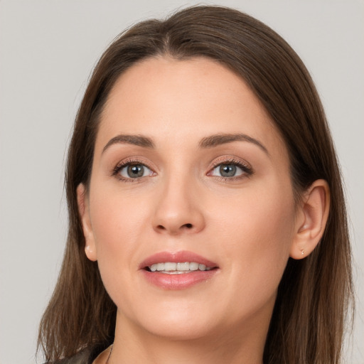 Joyful white young-adult female with long  brown hair and grey eyes