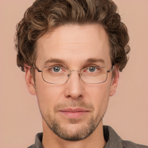 Joyful white adult male with short  brown hair and green eyes