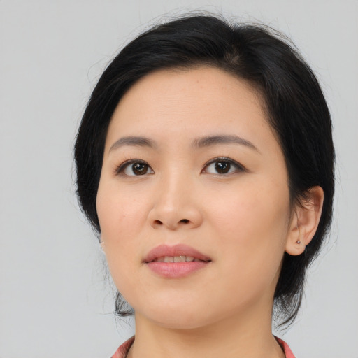 Joyful asian young-adult female with medium  black hair and brown eyes