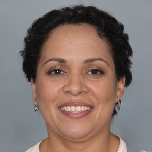Joyful latino adult female with short  brown hair and brown eyes