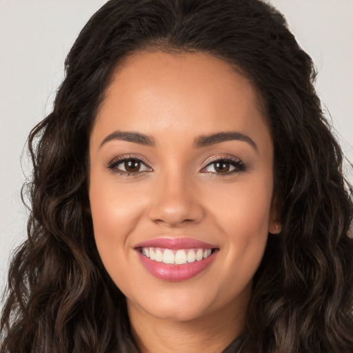 Joyful white young-adult female with long  brown hair and brown eyes